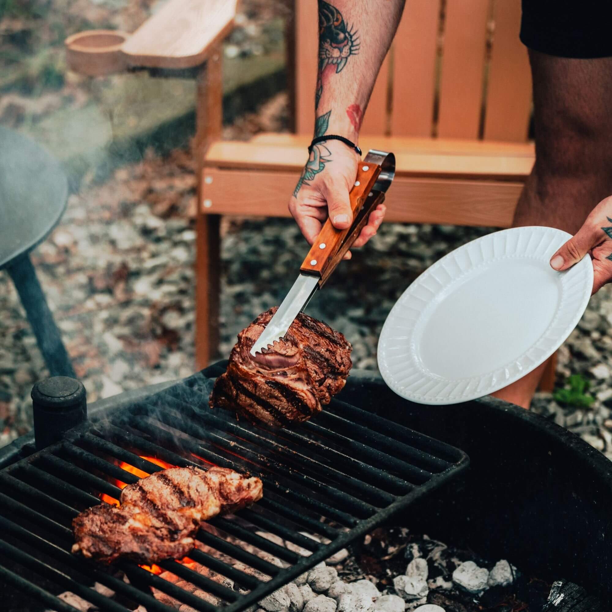 Firepit grill with steak cooking at Adohi Cabin, a romantic boho-modern getaway in North Georgia